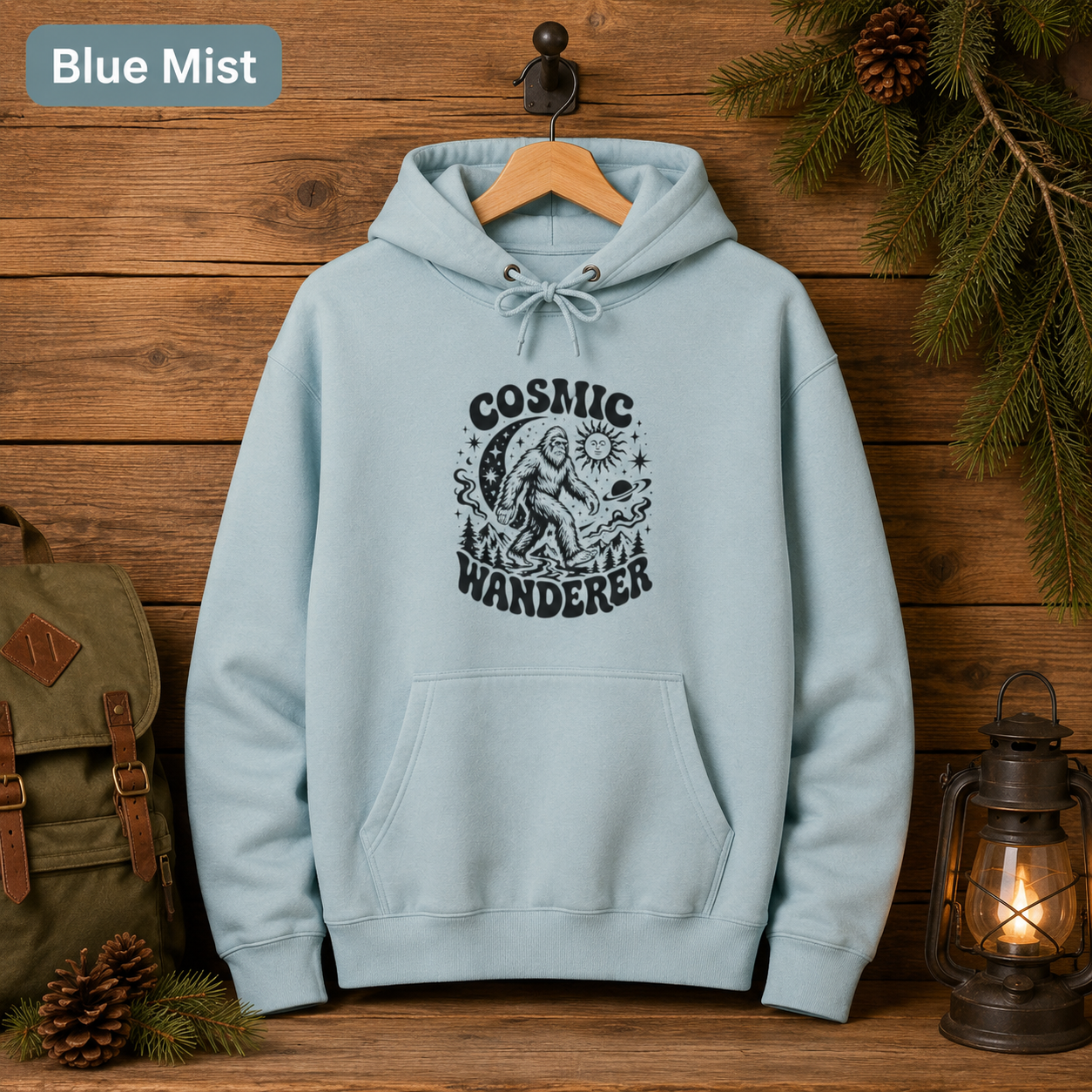 Cosmic Wanderer Sasquatch Hoodie, Retro Celestial Bigfoot Sweatshirt, Outdoorsy Camp Hoodie, Lane Seven Three-Panel Fleece Hoodie